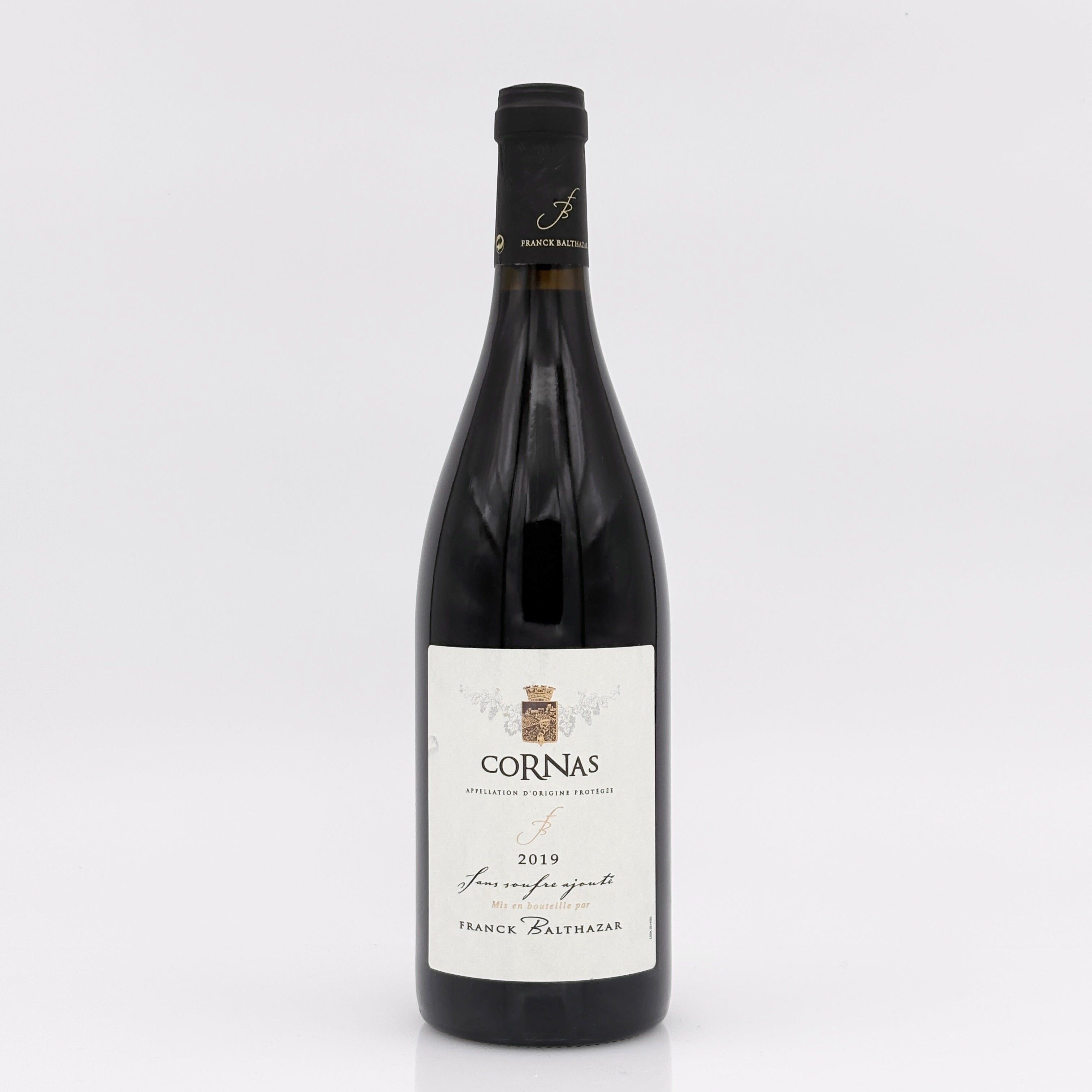 Wine bottle with 'Cornas' label on a white background