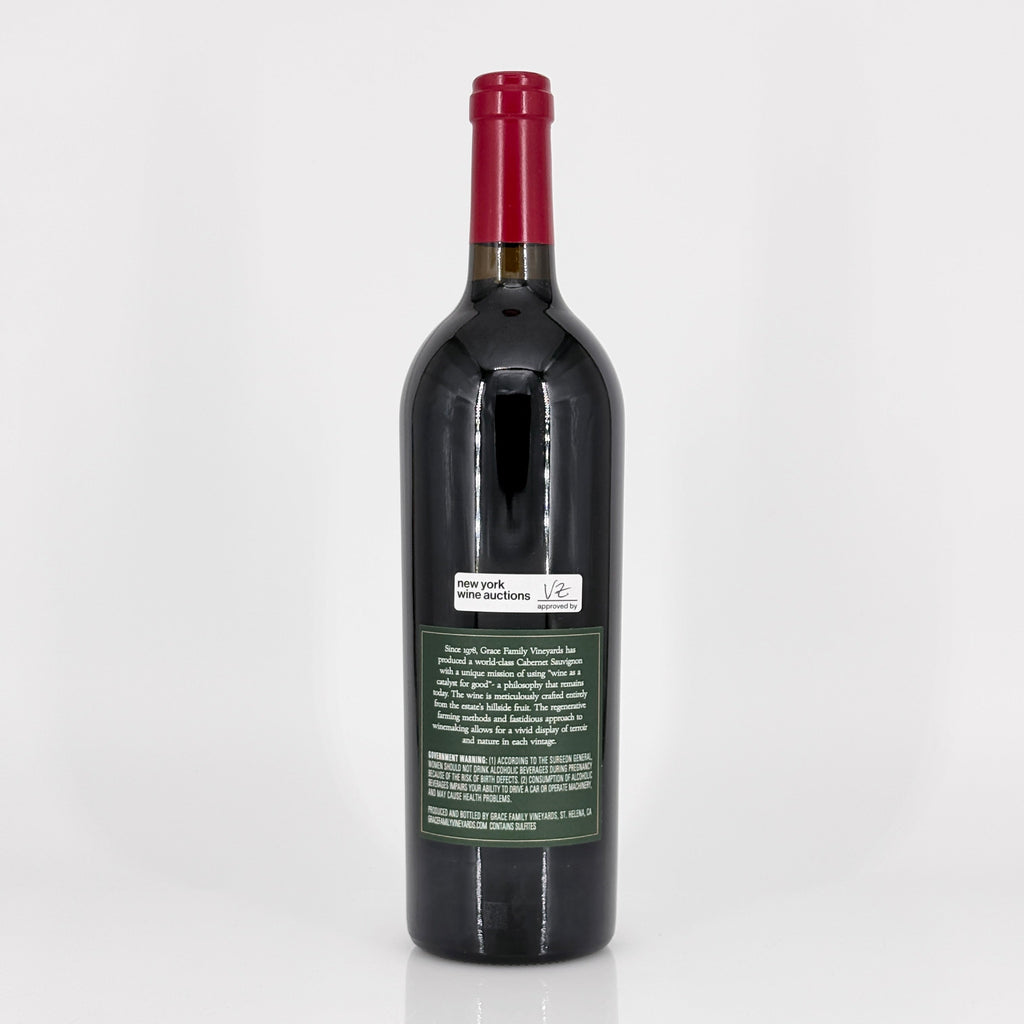 Red wine bottle with a visible label on a white background