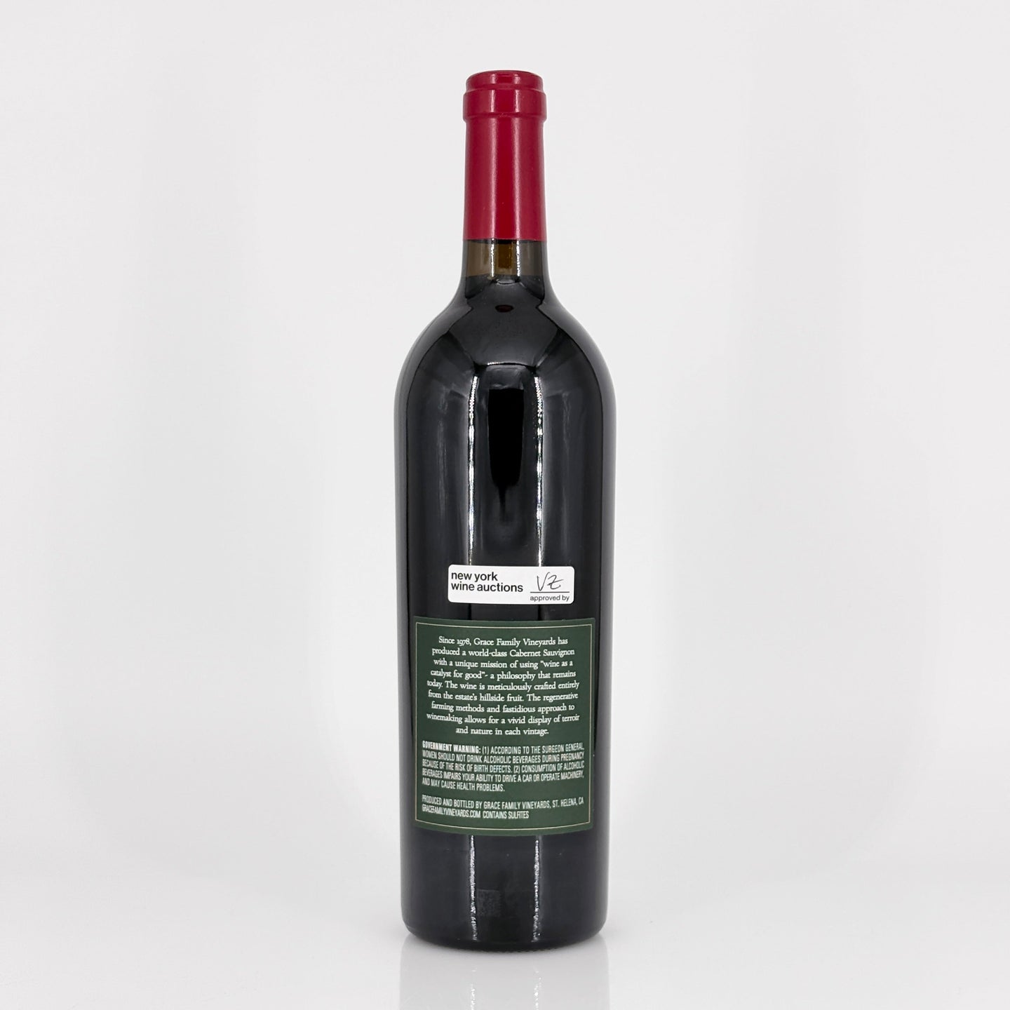 Red wine bottle with a visible label on a white background