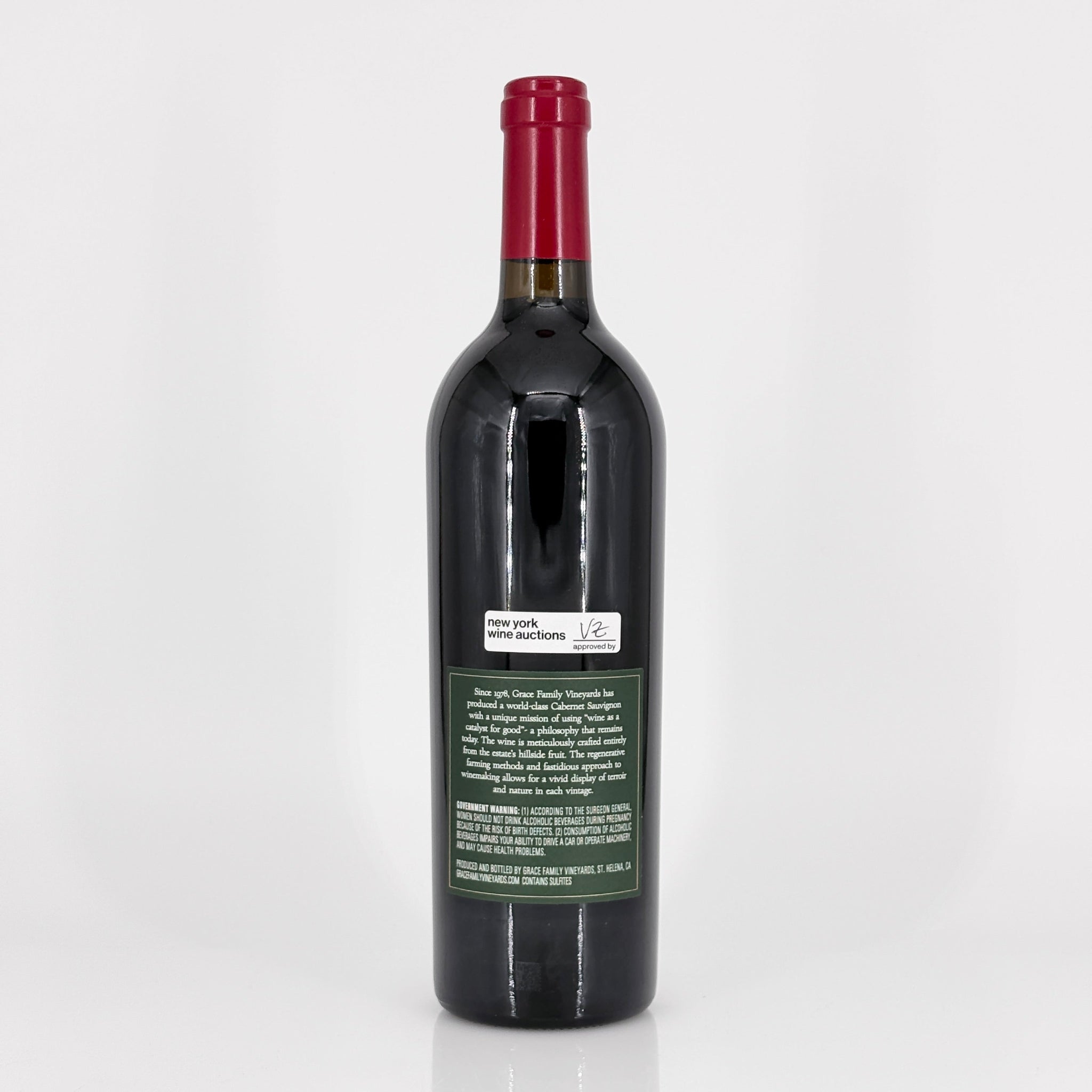 Red wine bottle with a visible label on a white background