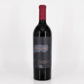 Red wine bottle with a dark label on a light gray background