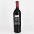 Red wine bottle with a visible label on a white background