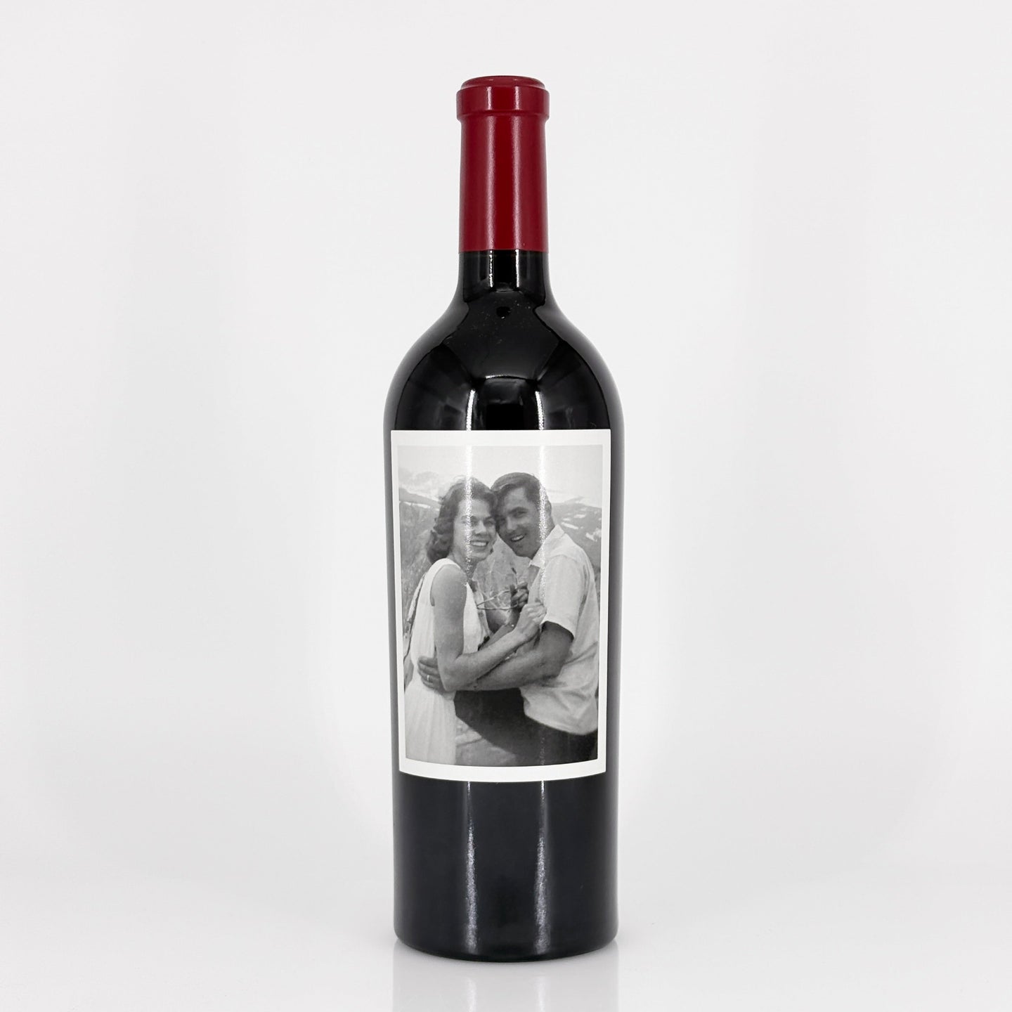 Wine bottle with a label featuring a black and white photo of a couple on a white background
