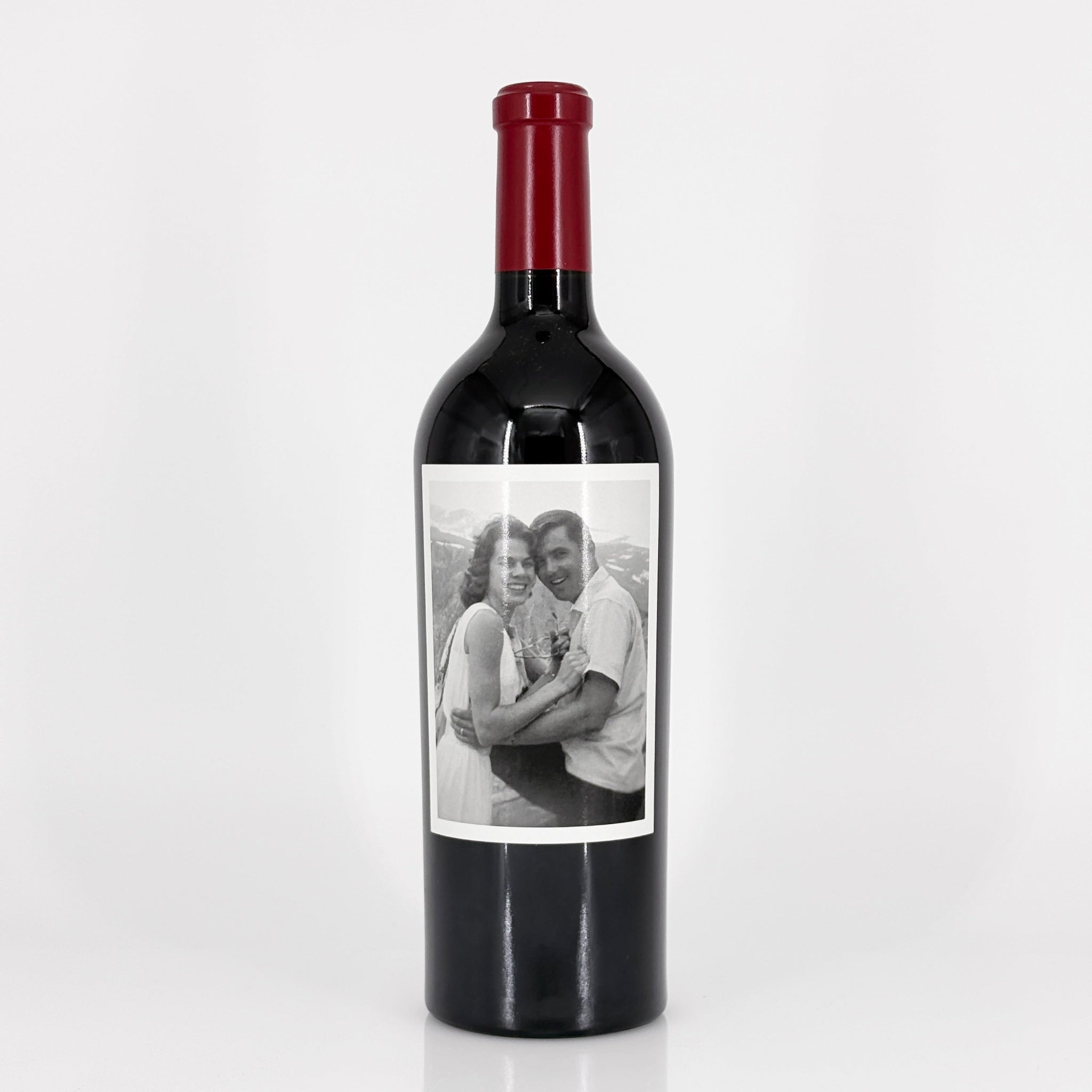 Wine bottle with a label featuring a black and white photo of a couple on a white background