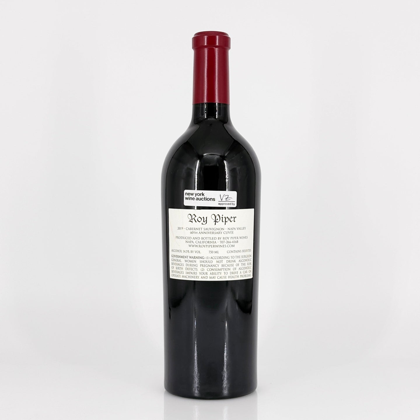 Red wine bottle with a visible label on a white background
