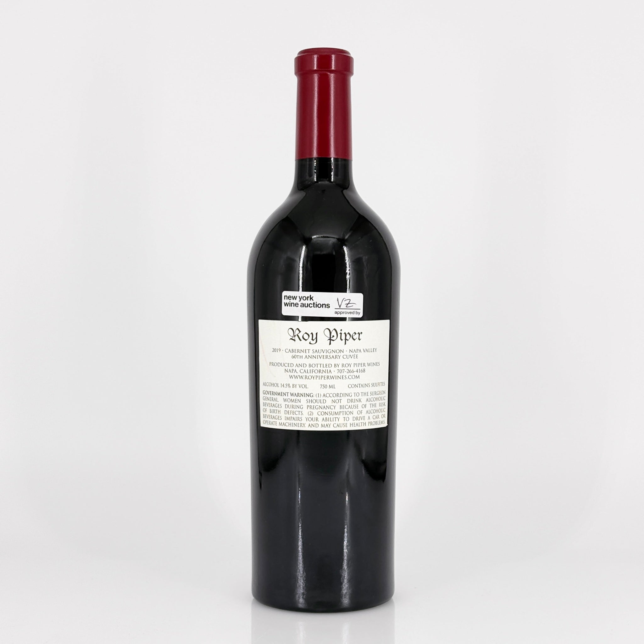 Red wine bottle with a visible label on a white background