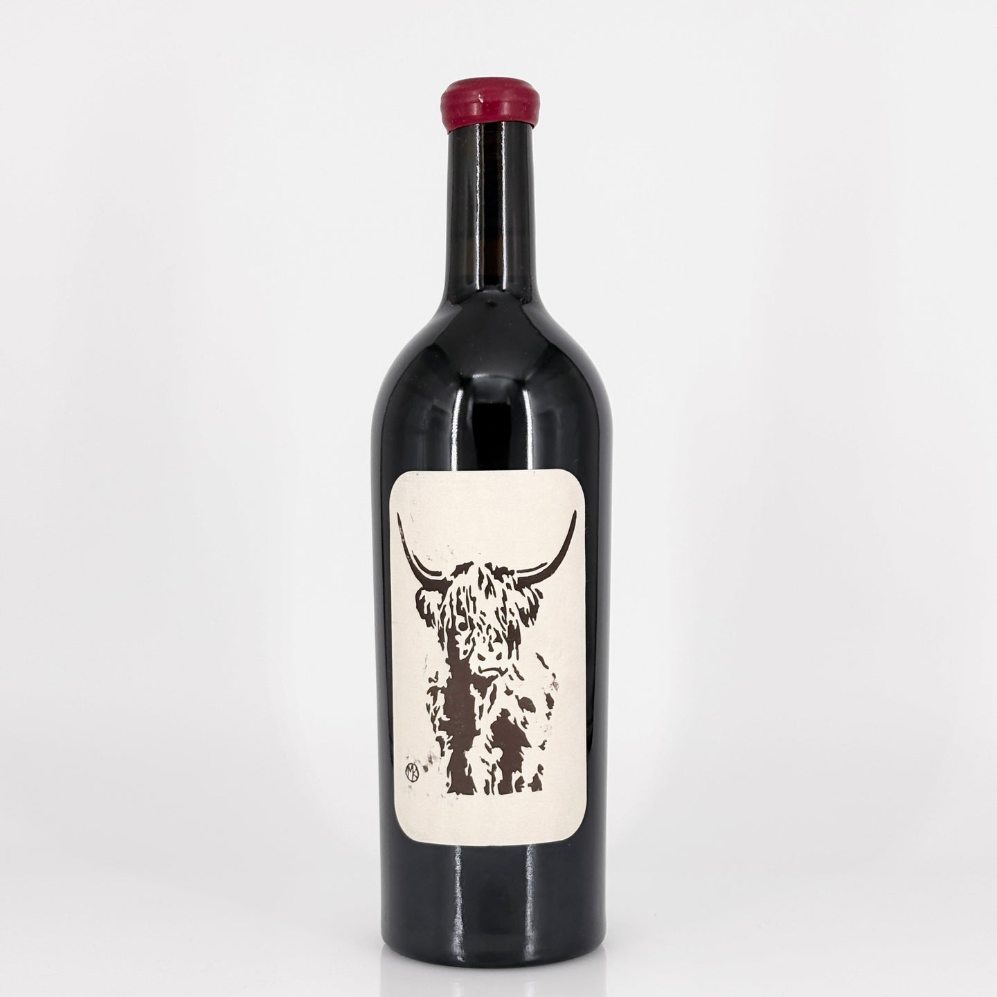 Wine bottle with a label featuring a cow design on a white background