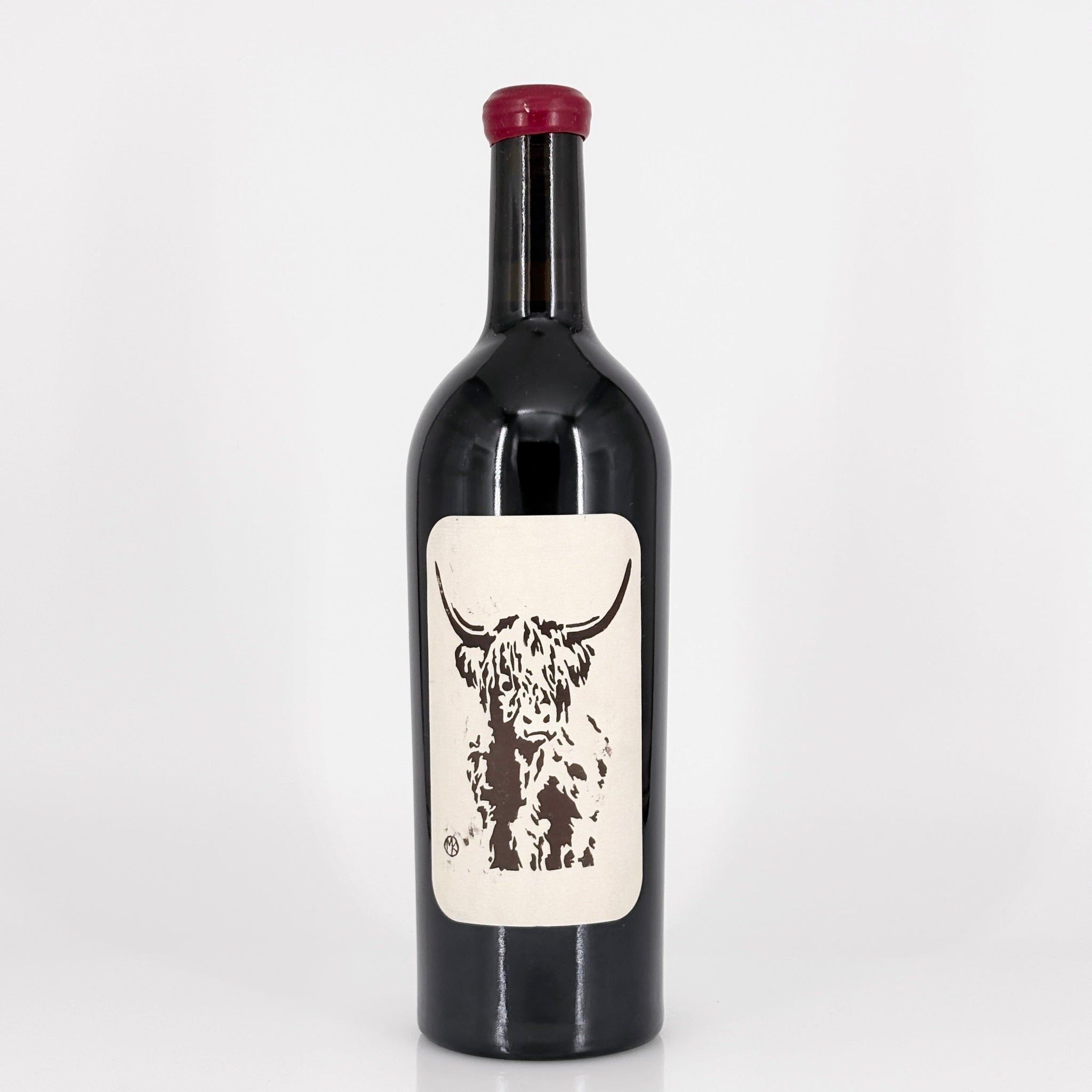 Wine bottle with a label featuring a cow design on a white background