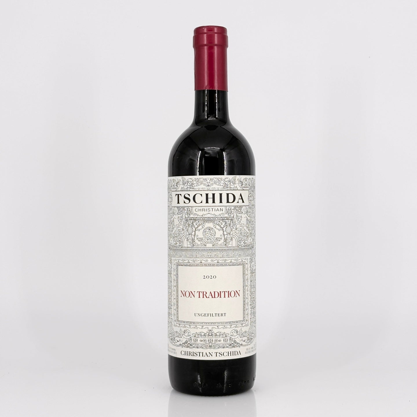 Red wine bottle with 'Tschida' label on a white background