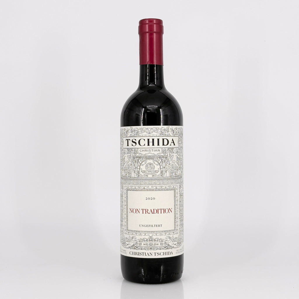 Red wine bottle with 'Tschida' label on a white background