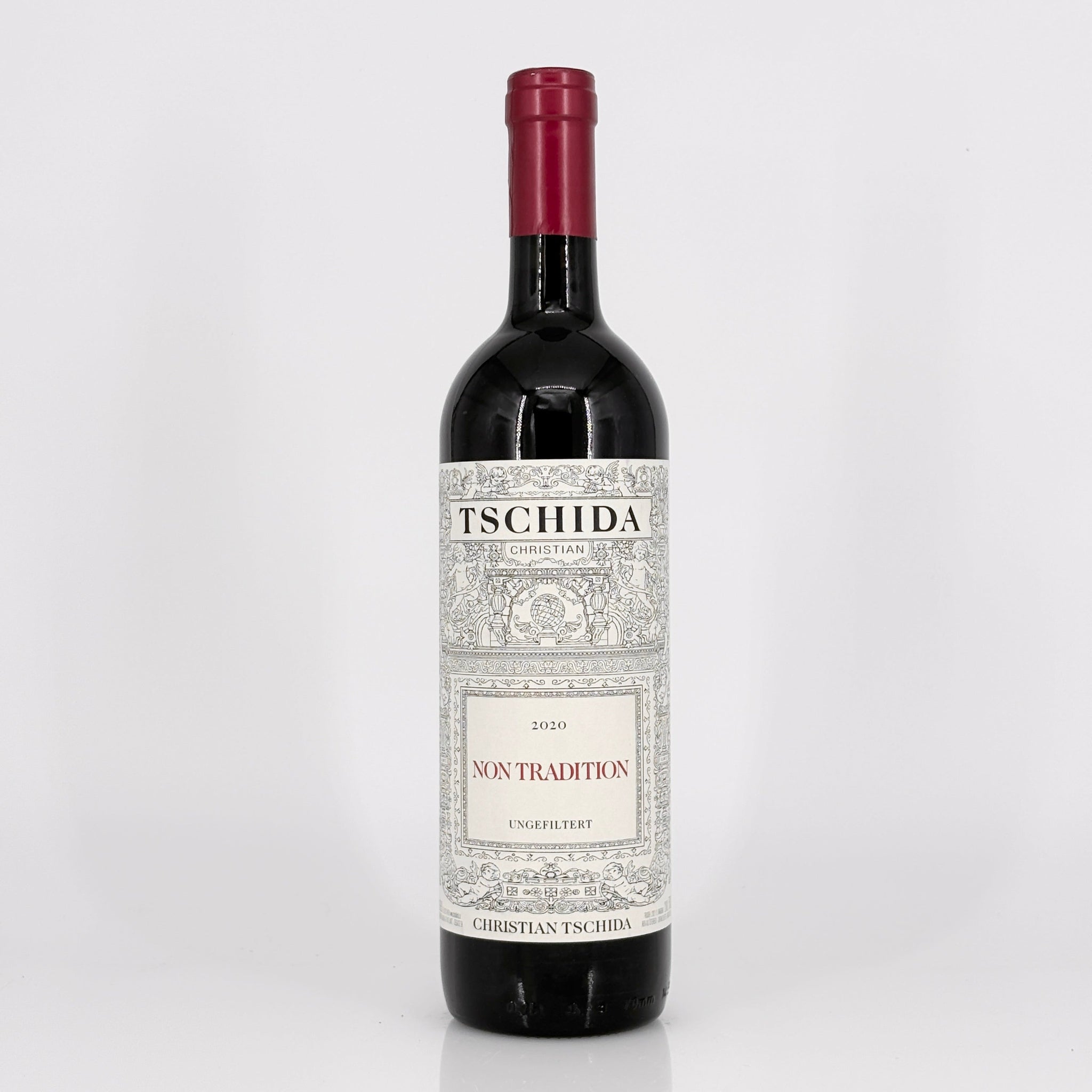 Red wine bottle with 'Tschida' label on a white background