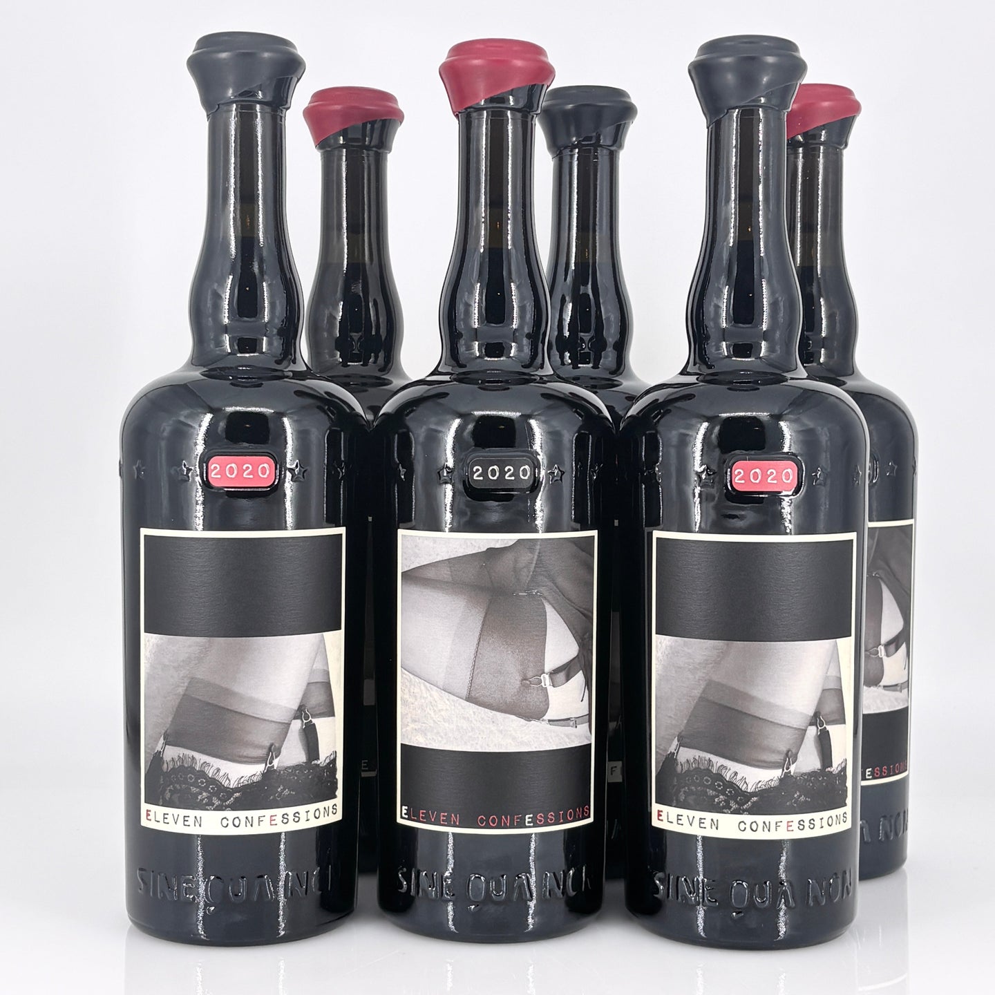Set of six black bottles with labels on a white background