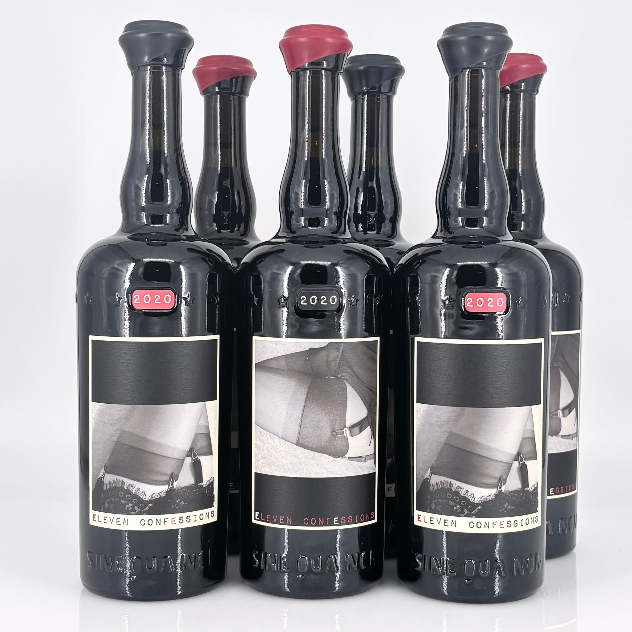 Set of six black bottles with labels on a white background