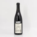 Black wine bottle with a label on a white background