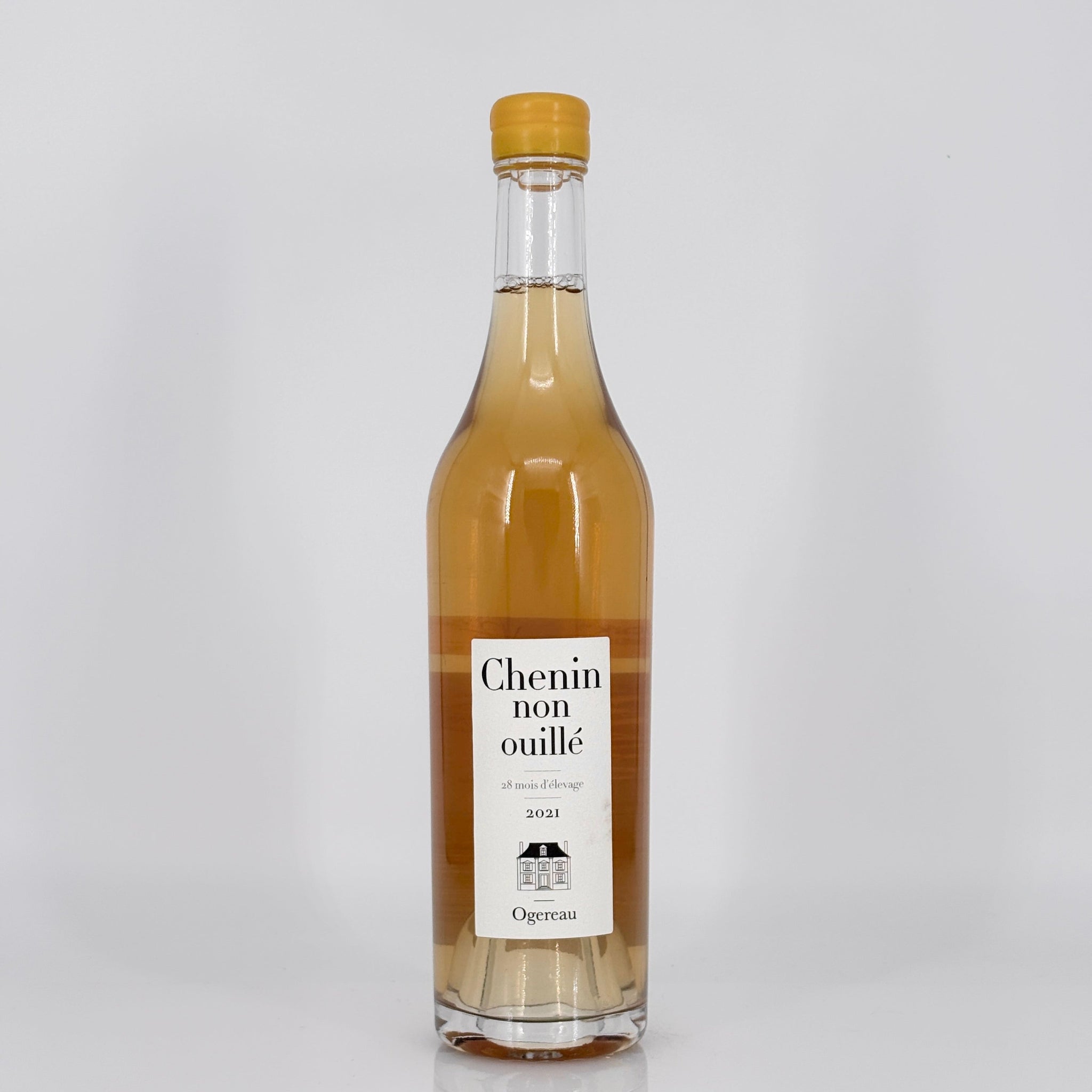 Bottle of Chenin non ouille wine with a cork cap on a light gray background
