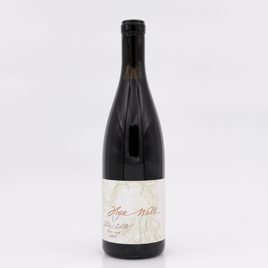Wine bottle with a white label on a light gray background
