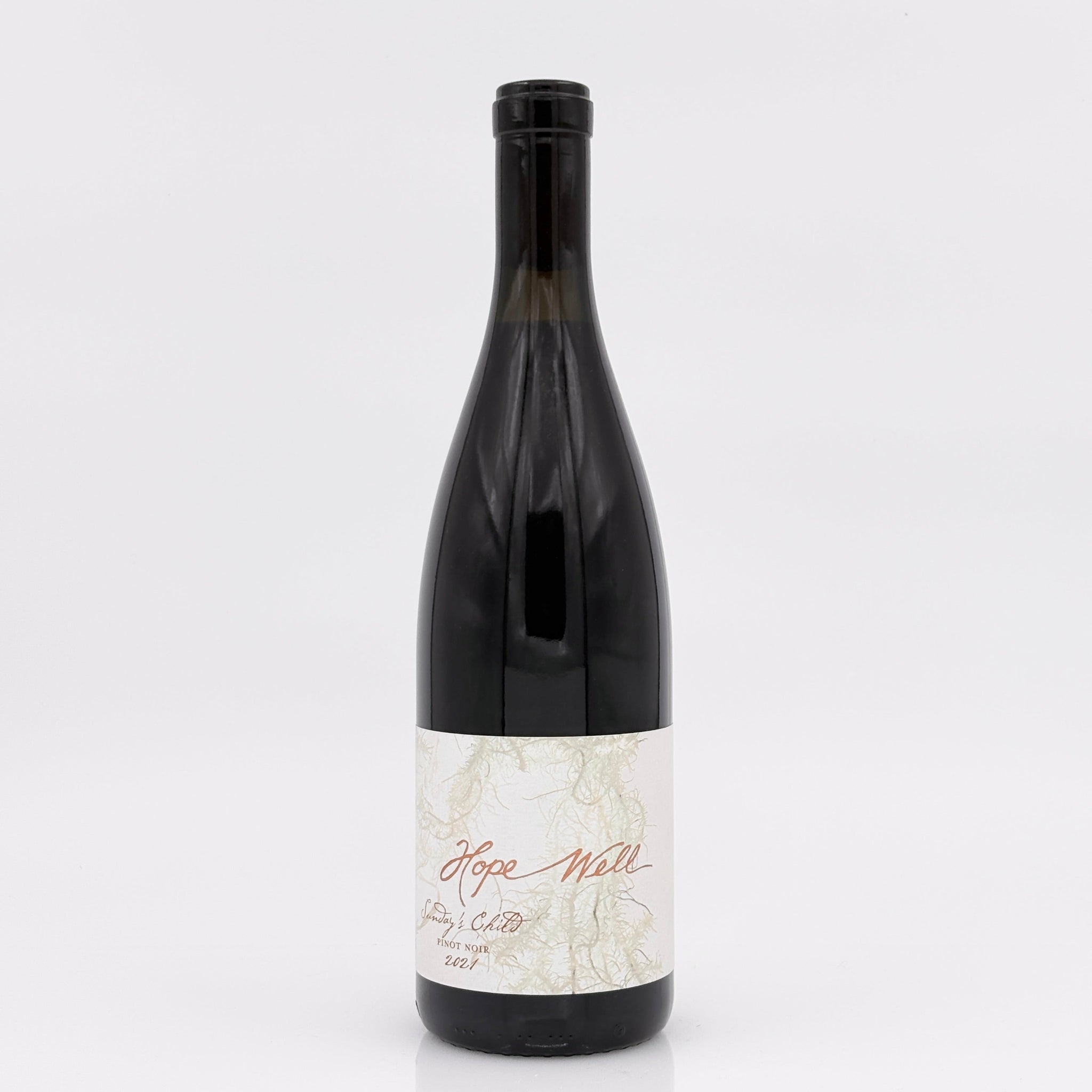 Wine bottle with a white label on a light gray background
