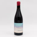 Red wine bottle with a label on a white background