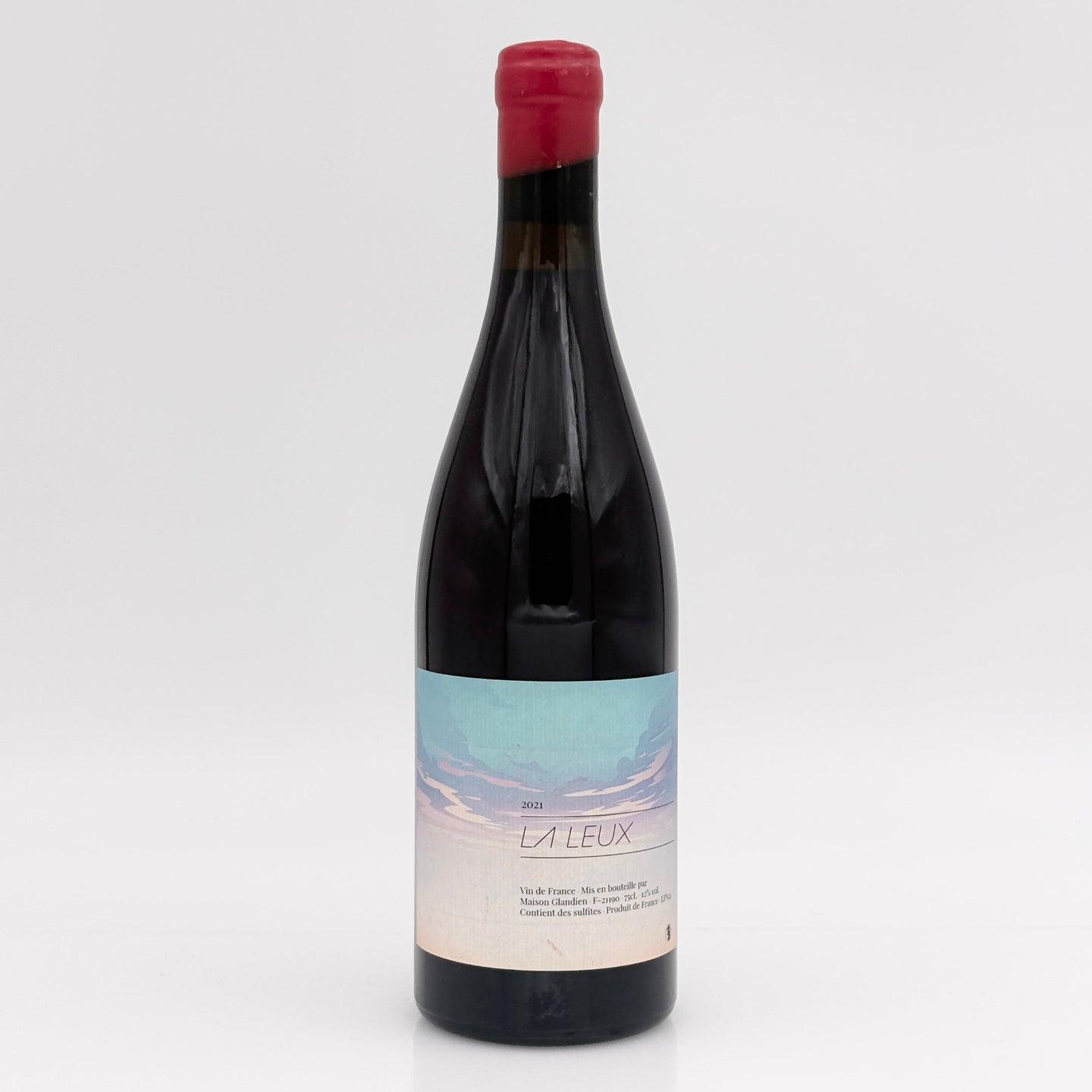 Red wine bottle with a label on a white background