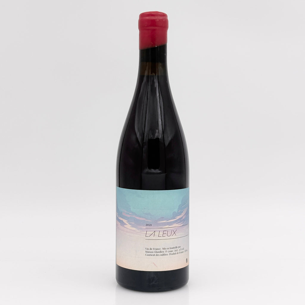 Red wine bottle with a label on a white background