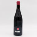 Wine bottle with a red cap on a white background