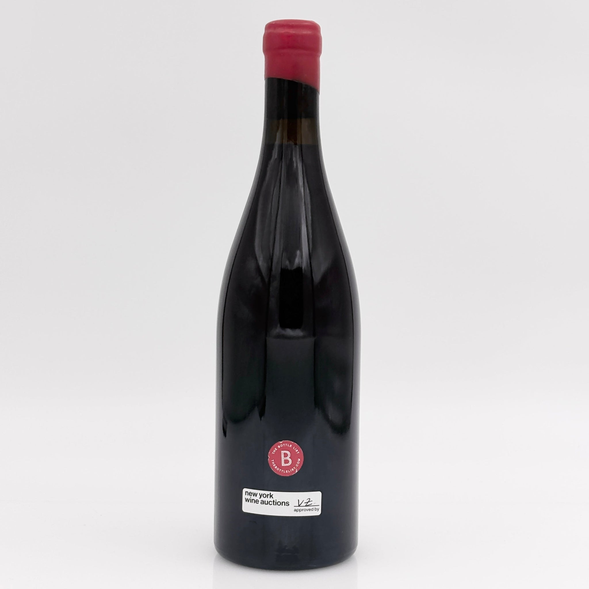 Wine bottle with a red cap on a white background