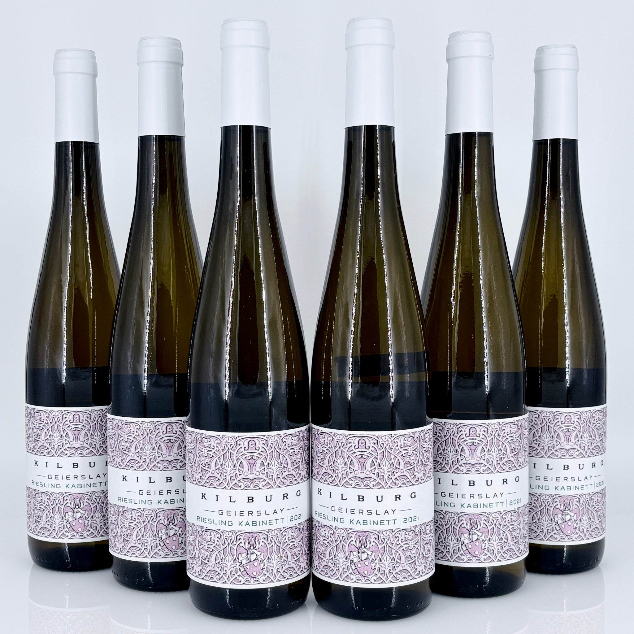 Six bottles of Kilburg wine with decorative labels on a white background