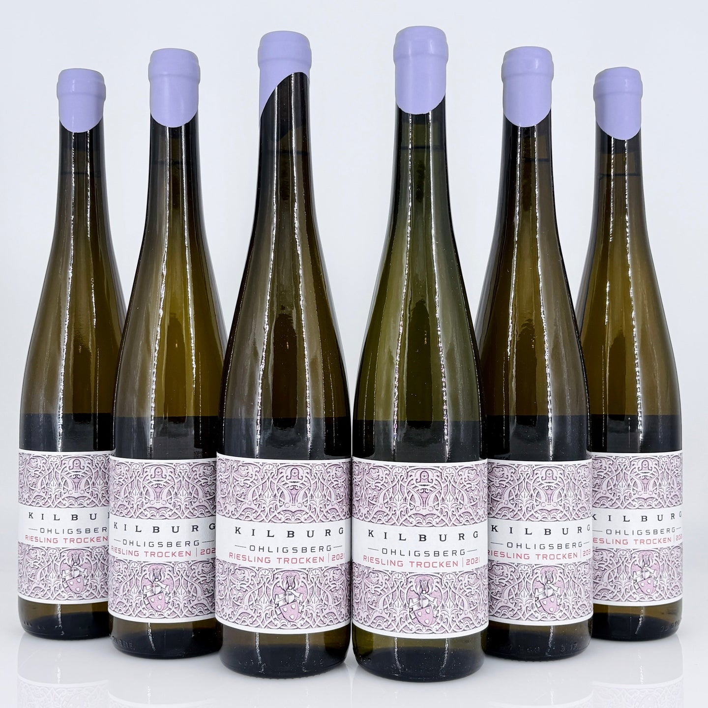 Six bottles of Kilburg wine with purple bottle caps on a white background