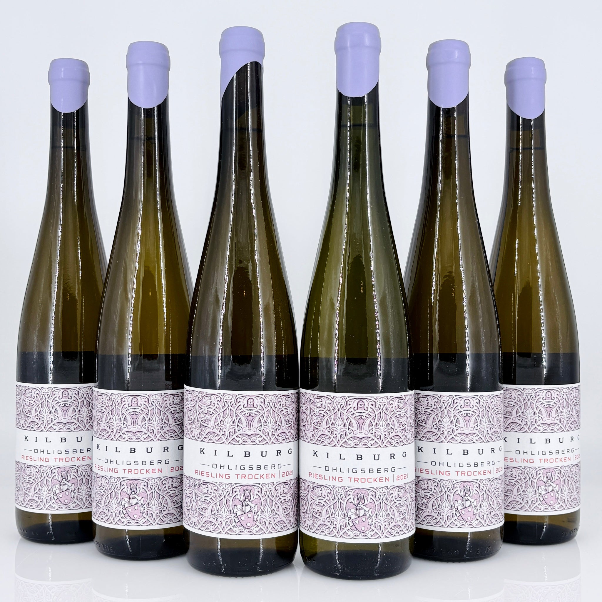 Six bottles of Kilburg wine with purple bottle caps on a white background