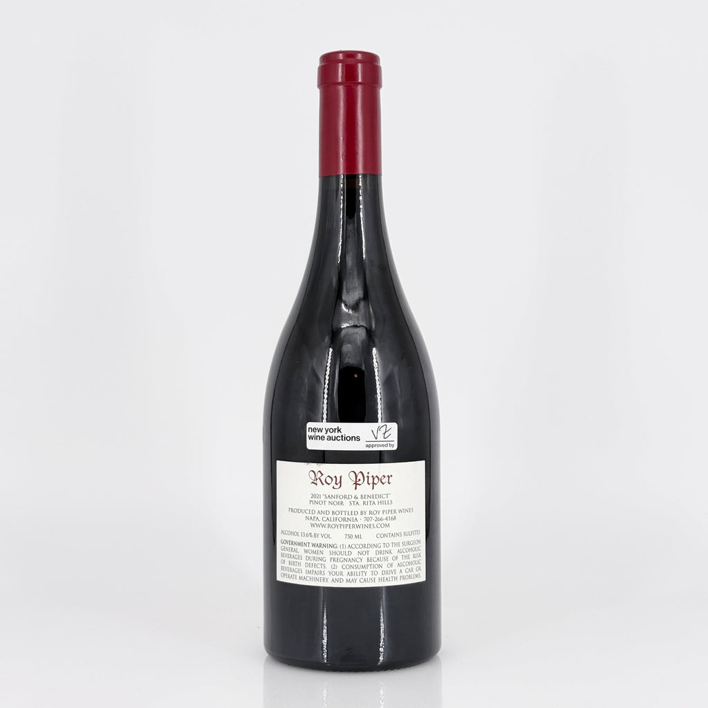 Red wine bottle with a visible label on a white background