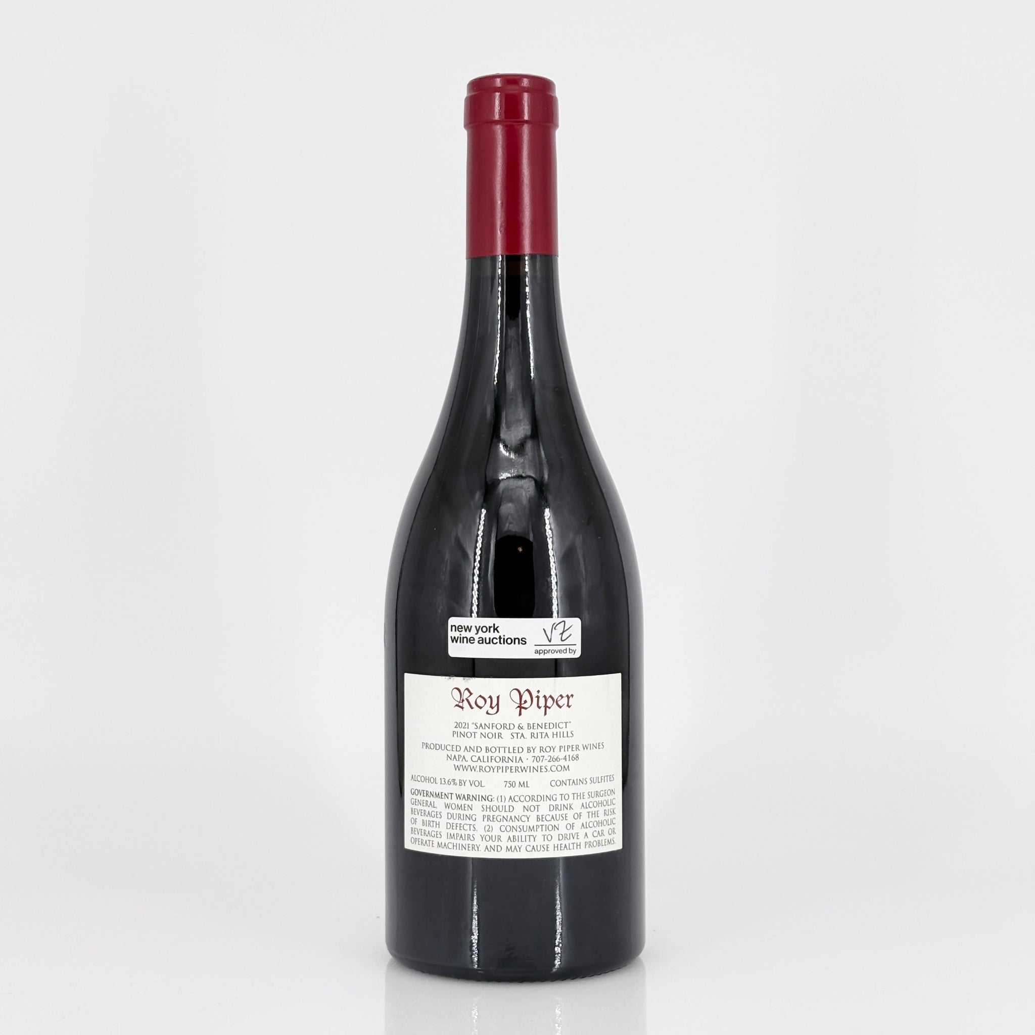 Red wine bottle with a visible label on a white background