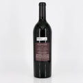 Red wine bottle with a label on a white background