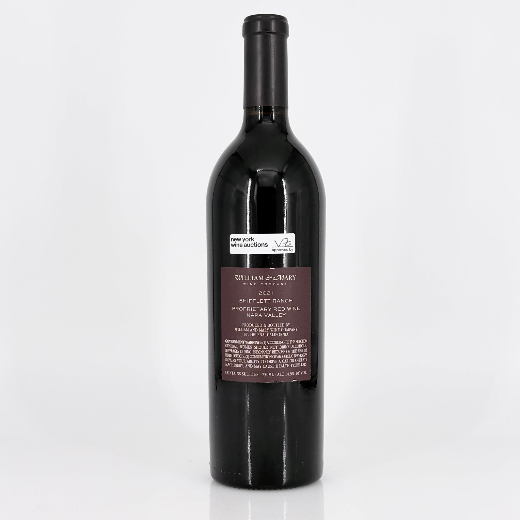 Red wine bottle with a label on a white background