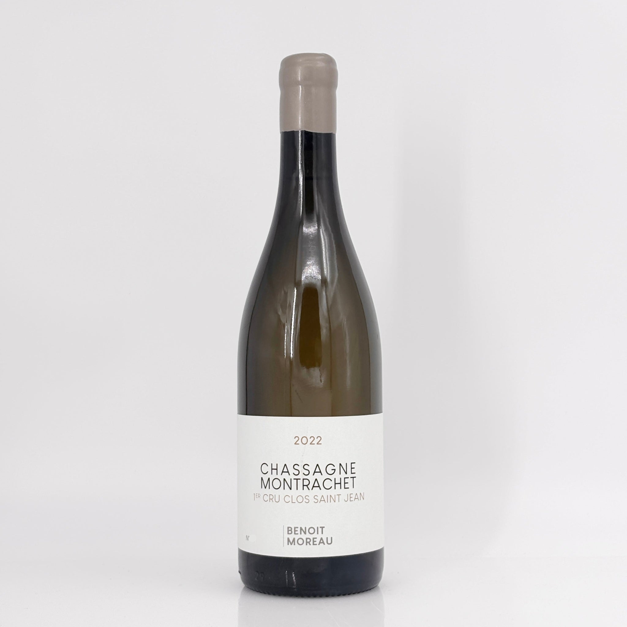 Wine bottle labeled 'Chassagne Montrachet' on a white background