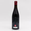 Red wine bottle with a visible label on a white background