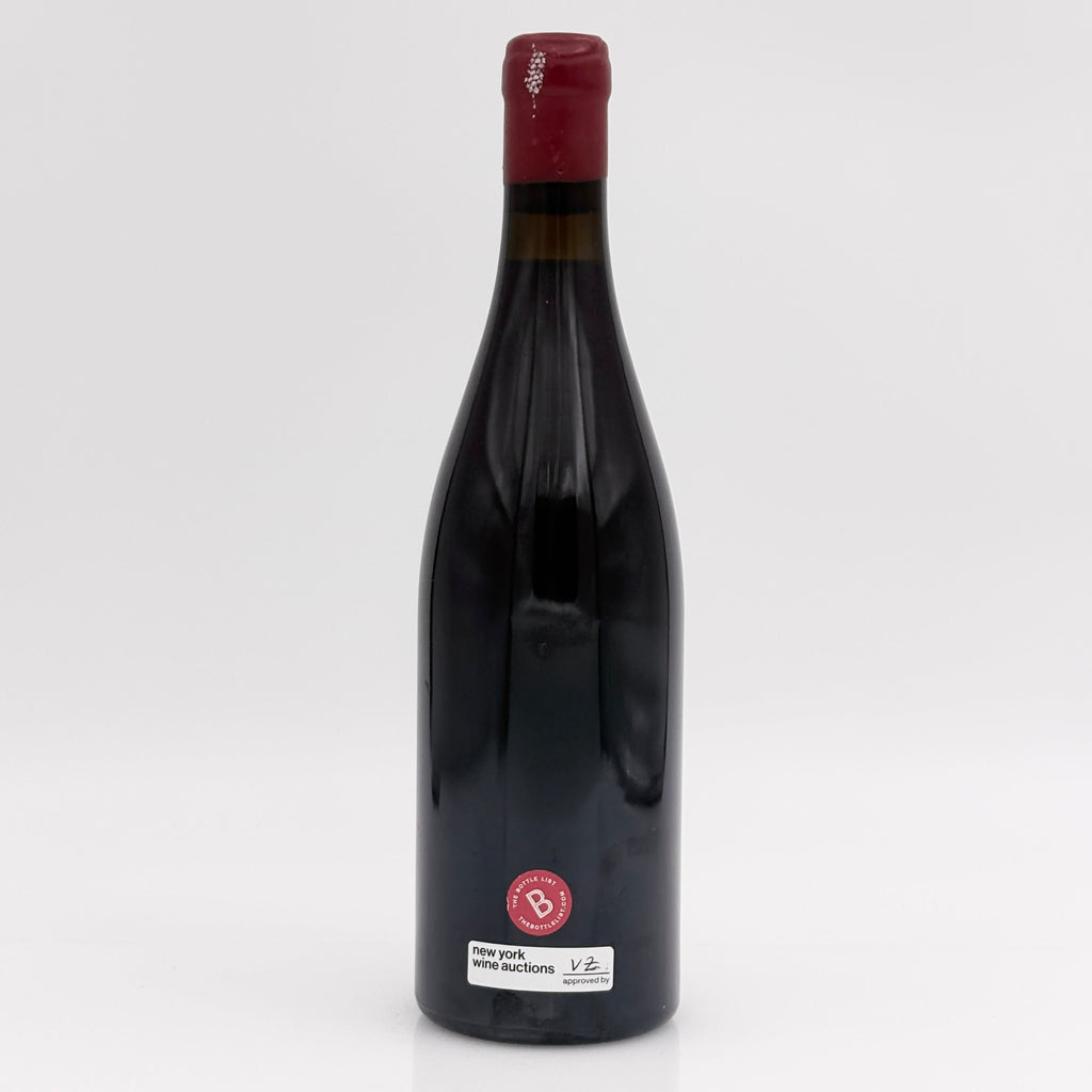 Red wine bottle with a visible label on a white background