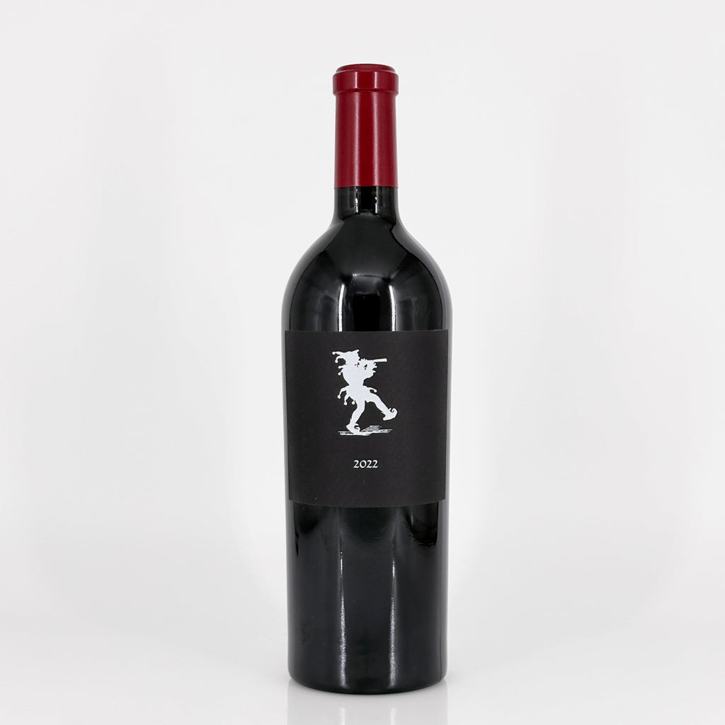 Red wine bottle with a black label on a white background