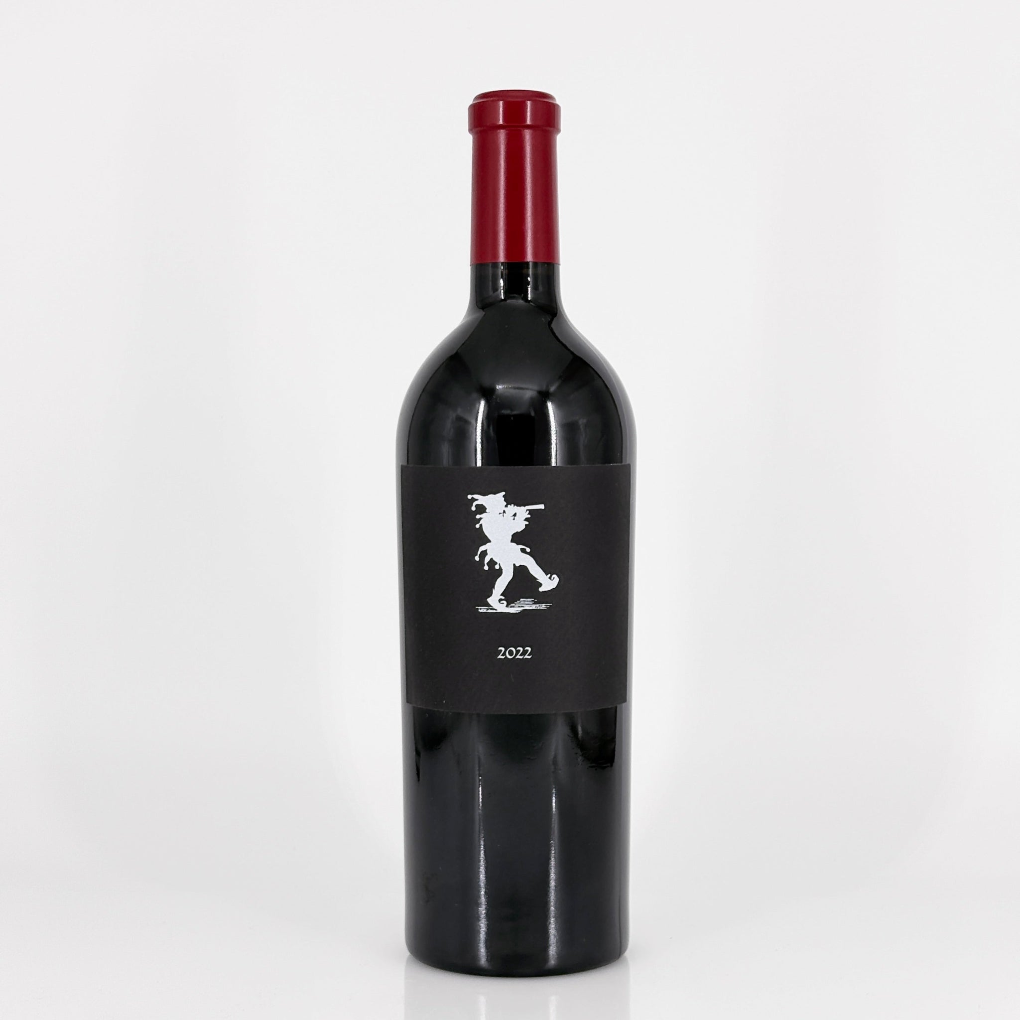 Red wine bottle with a black label on a white background