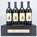 4 bottles of wine on top of a wooden box