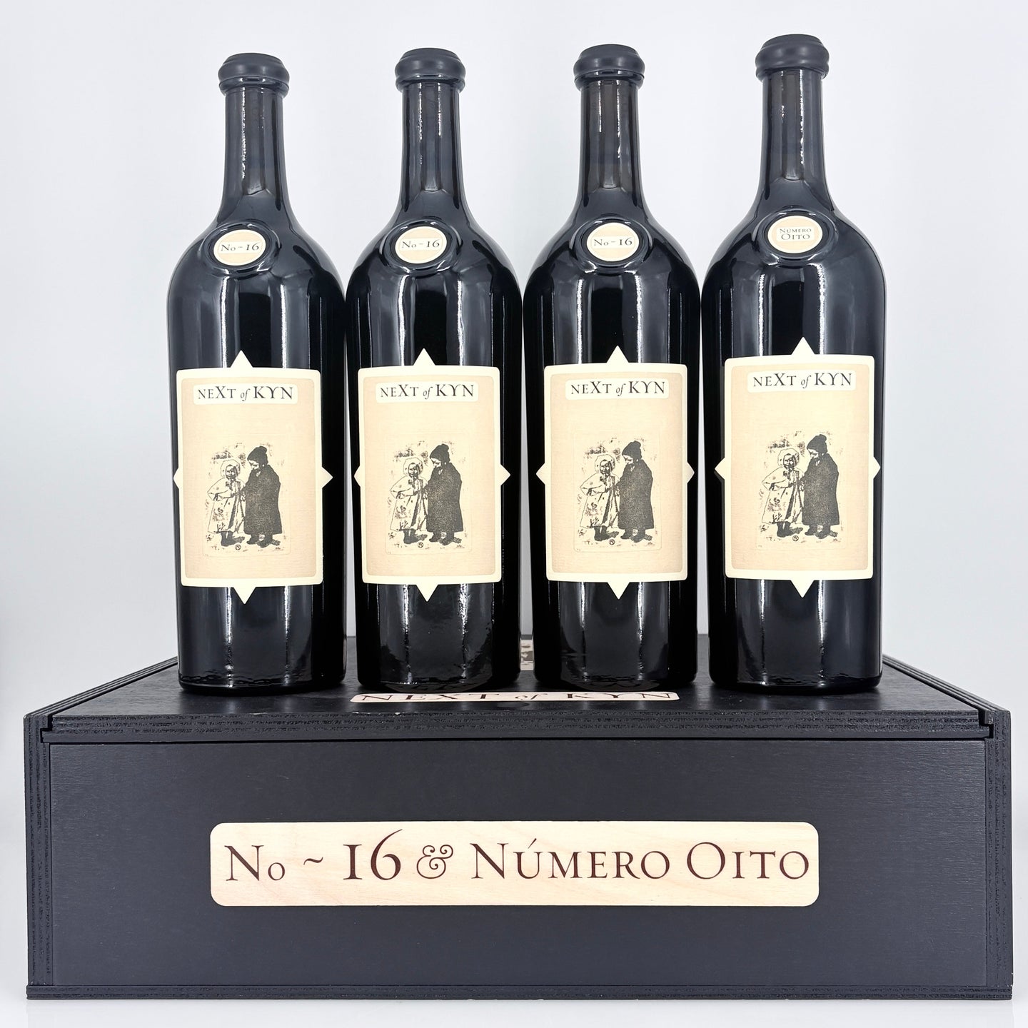 4 bottles of wine on top of a wooden box