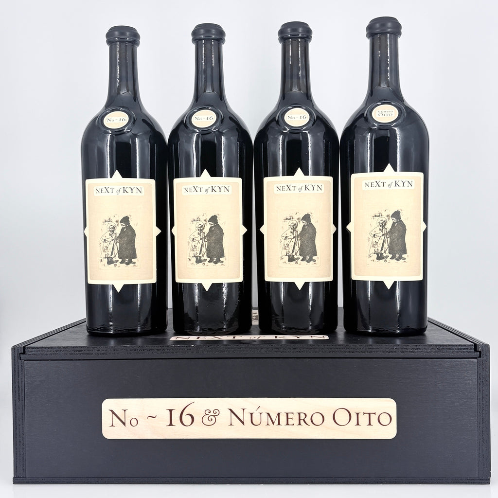 4 bottles of wine on top of a wooden box