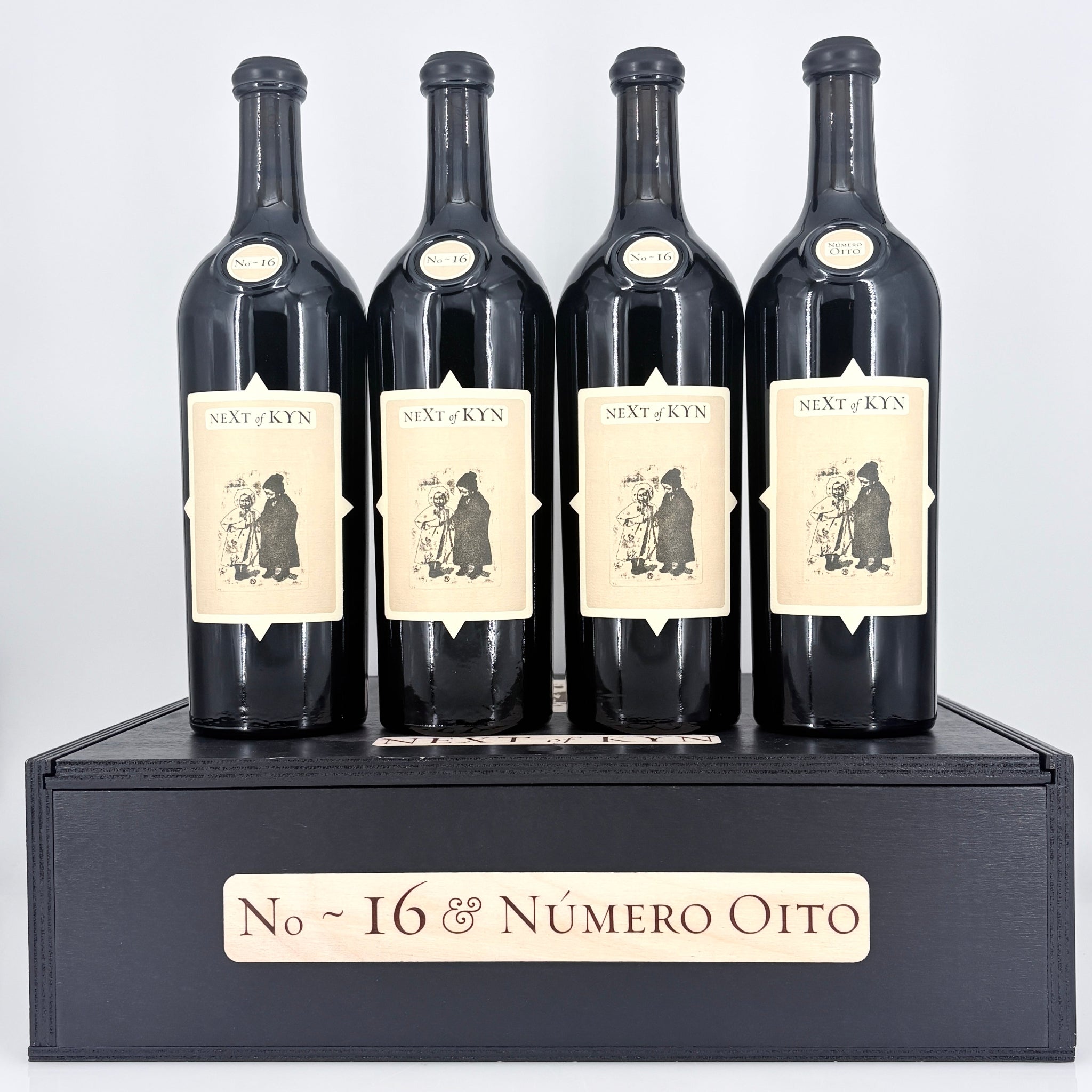 4 bottles of wine on top of a wooden box