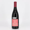 Red wine bottle with a pink label on a white background