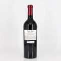 Red wine bottle with a visible label on a white background