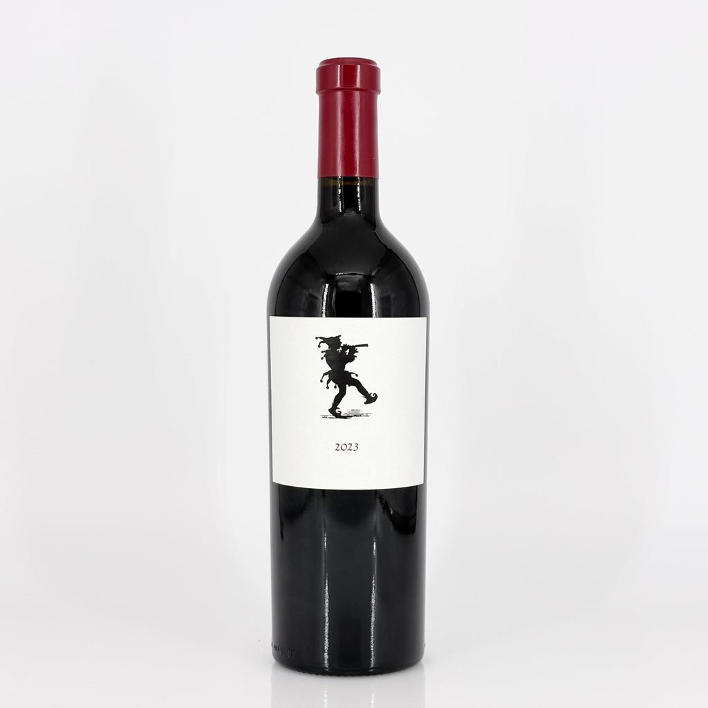 Red wine bottle with a white label featuring a black silhouette on a white background