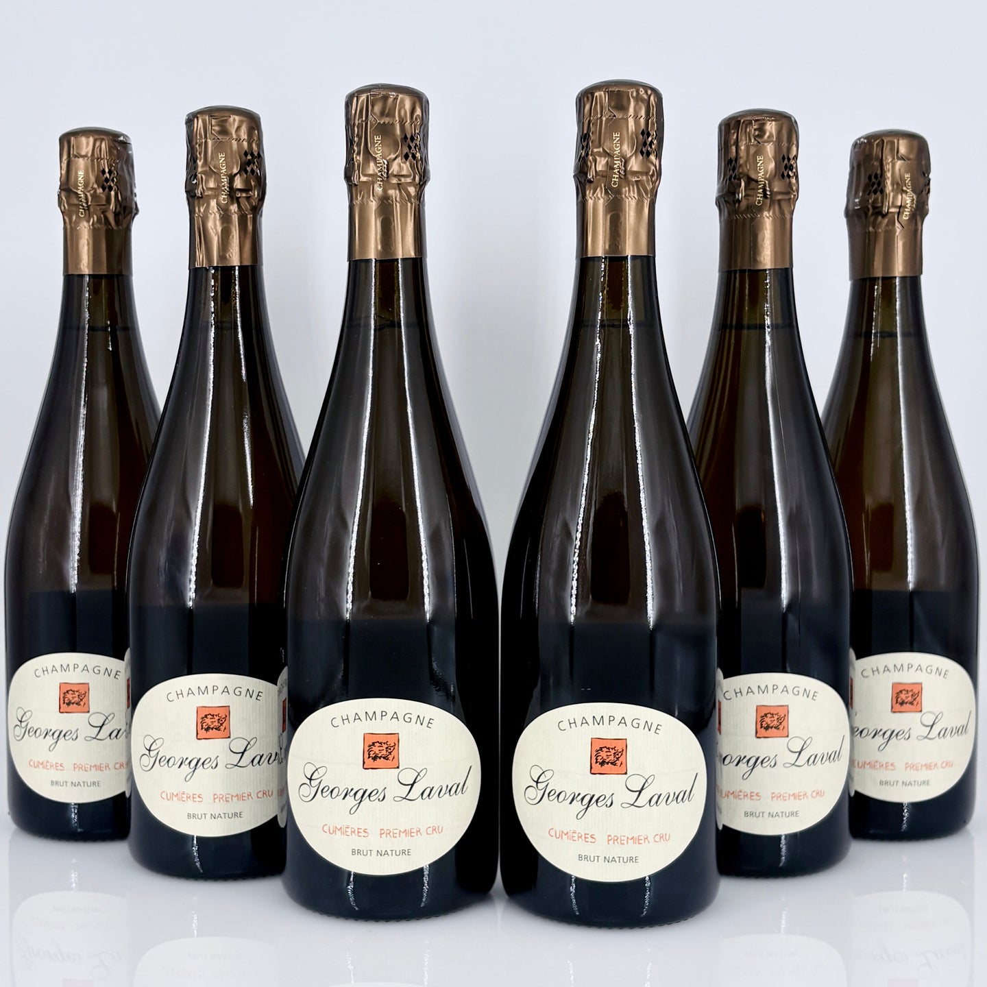 Six bottles of Georges Laval champagne on a white background
