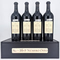 Four bottles of wine from 'Next of Kin' on a black stand with 'No. 16 & Néméro Oito' branding.